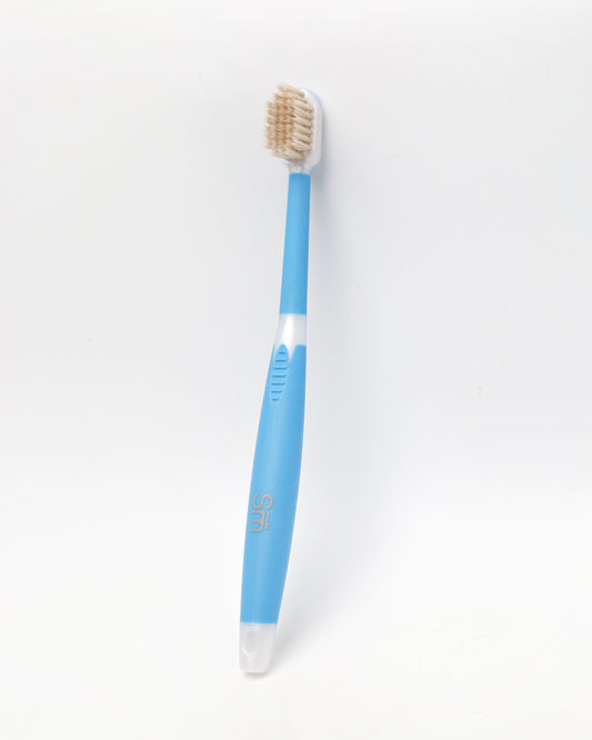 Blue Miswak toothbrush on a white background